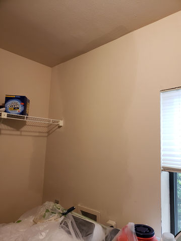 Interior room with beige walls and a window; house paint near me.