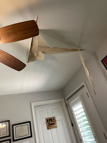Ceiling damage with drywall Repair. White door and wall, near me