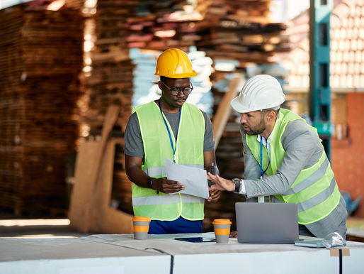 Construction guys talking about a piece of paper