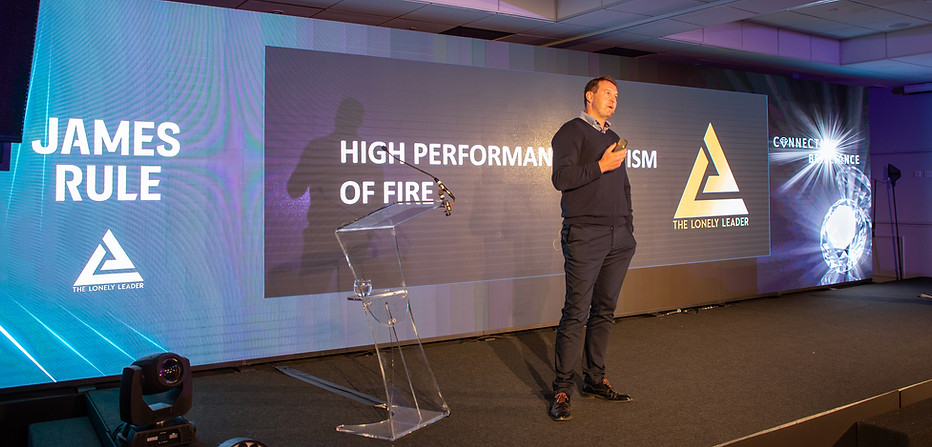 James Rule speaking on stage at the Care Conference