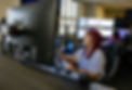 Telecommunicator sitting at computer desk