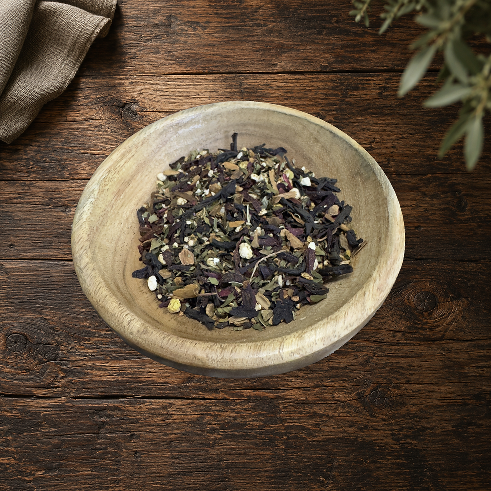 Real Crimson Mist loose tea blend in the original wooden bowl on a warm wood table