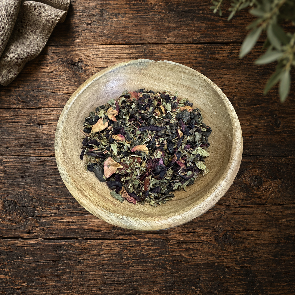 Real Sacred Vitality loose tea blend in the original wooden bowl on a warm wood table
