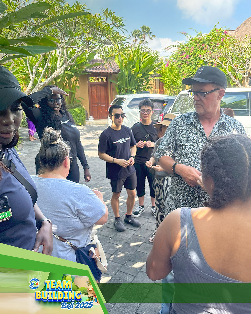 A mixed group of people in casual attire participates in a group briefing for a team challenge.