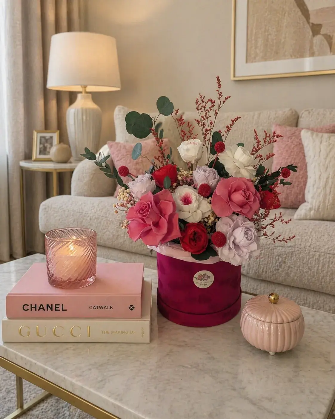 Blush Romance Bloom flower box with pink, red and white blooms and eucalyptus on a marble coffee table.