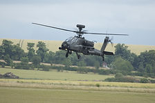 UK Apache military attack helicopter at low level in wooded countryside.jpg
