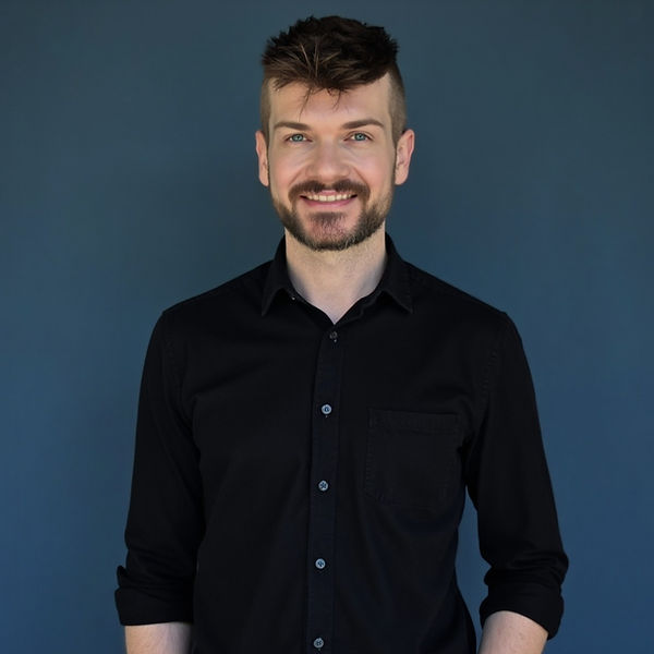 Anthony Hansen, portrait against a blue backdrop, professional counsellor and EMDR therapist