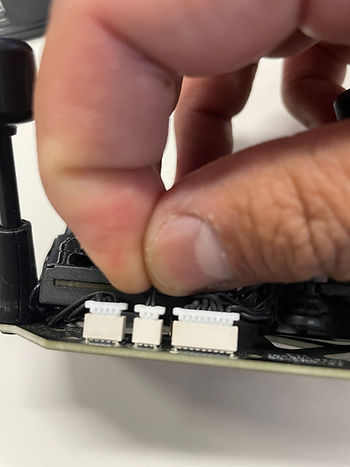 It is the middle plug. Hold both wires and pull "gently" until it unplugs