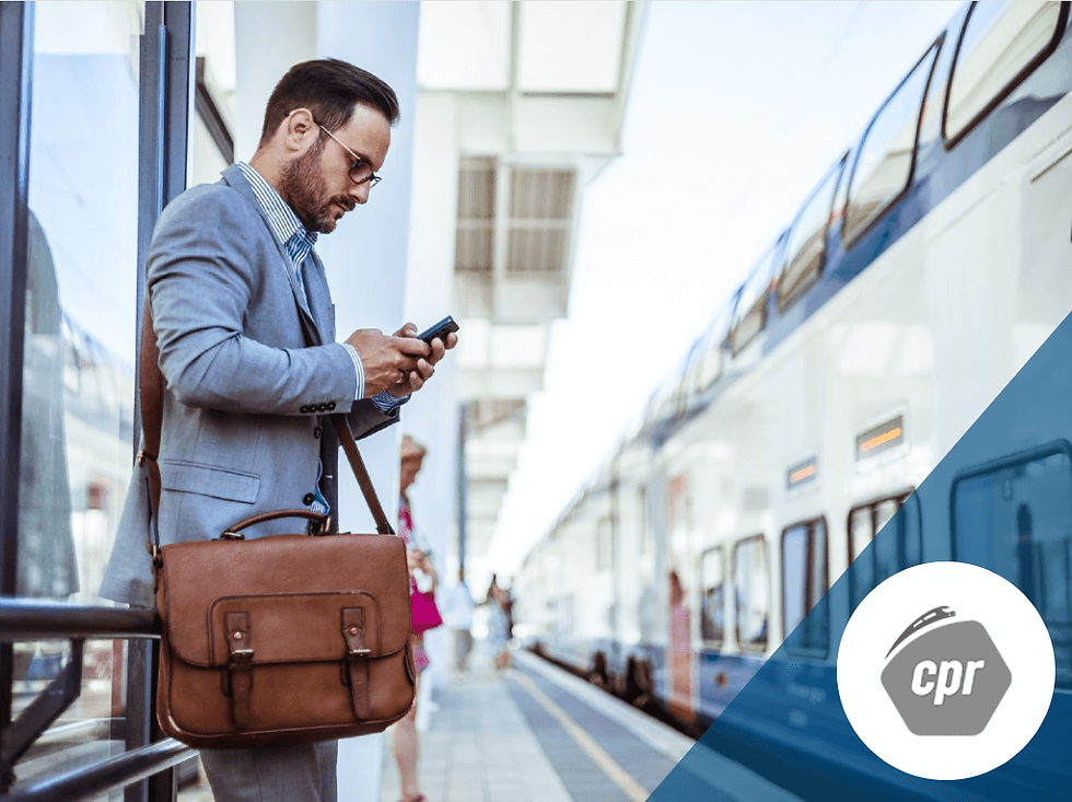 Man waiting for his train while looking at his phone