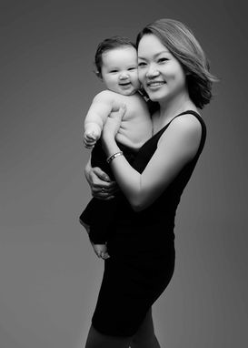 Mother holding newborn during intimate studio motherhood session in South Florida