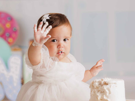Baby in boho outfit smashing cake in Coral Springs studio