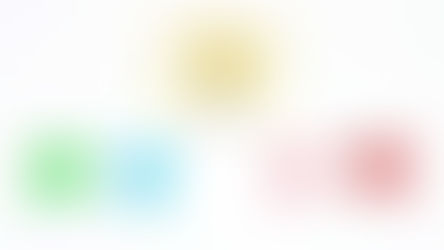 A light bulb with bright yellow light surrounded by colourful balled up pieces of paper