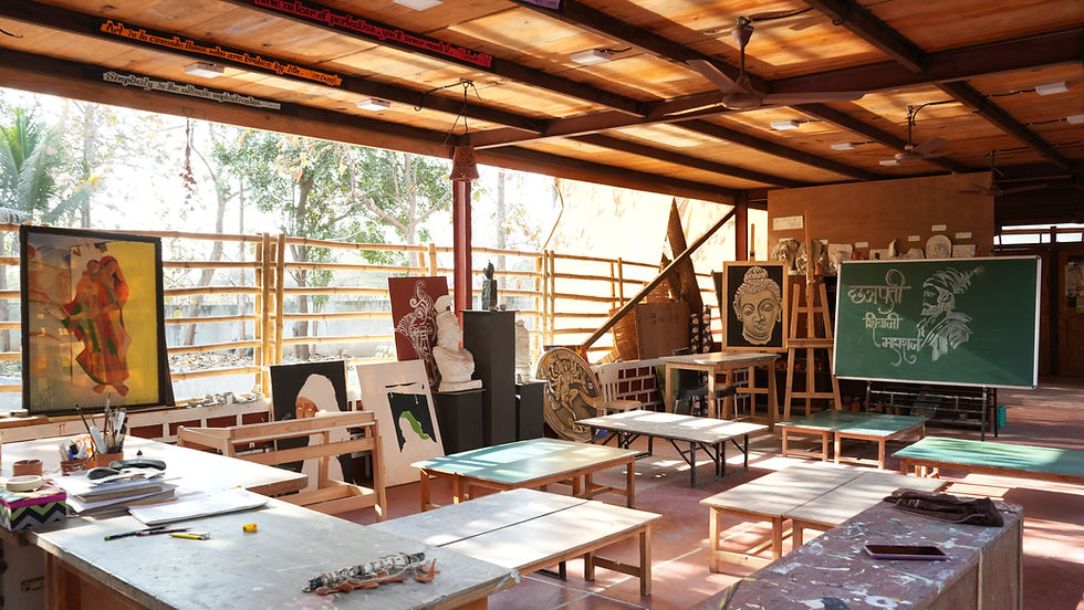 Art room with benches and colorful paintings on display.