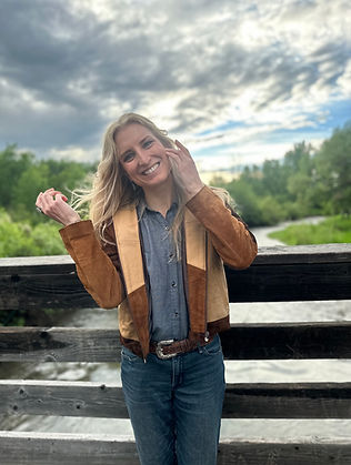 Holistic healthcare provider Dr. Kaylie Rozen smiling outdoors, reflecting compassionate & personalized care at Rozen Health