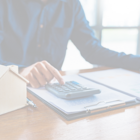 Man using a calculator to figure out his mortgage