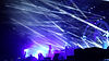 Live concert stage illuminated with blue and white lighting.