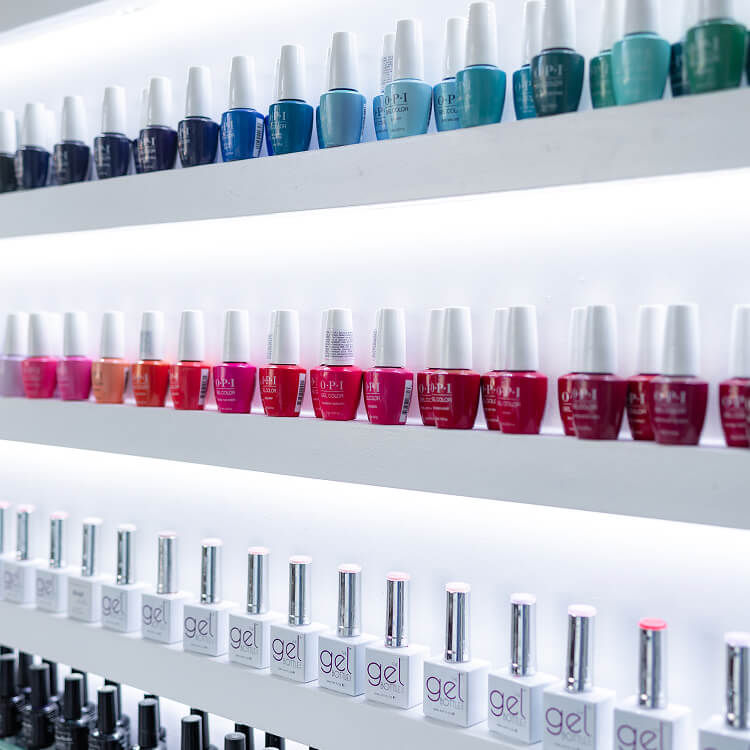 Wide selection of gel and regular nail polishes displayed at a modern manicure and pedicure salon