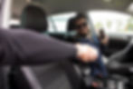 young-man-with-phone-greeting-friend-while-sitting-in-car.jpg