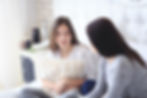 A mother sitting on her daughter's bed with her daughter talking. Her daughter is holding a pillow against her chest. This represents the need for treatment for panic attacks katy, tx and ptsd counseling katy, tx 77494. This also represents the need for ptsd counseling katy texas and neurofeedback for ptsd houston texas.