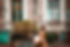 side-view-young-woman-walking-by-building-with-graffiti-text.jpg
