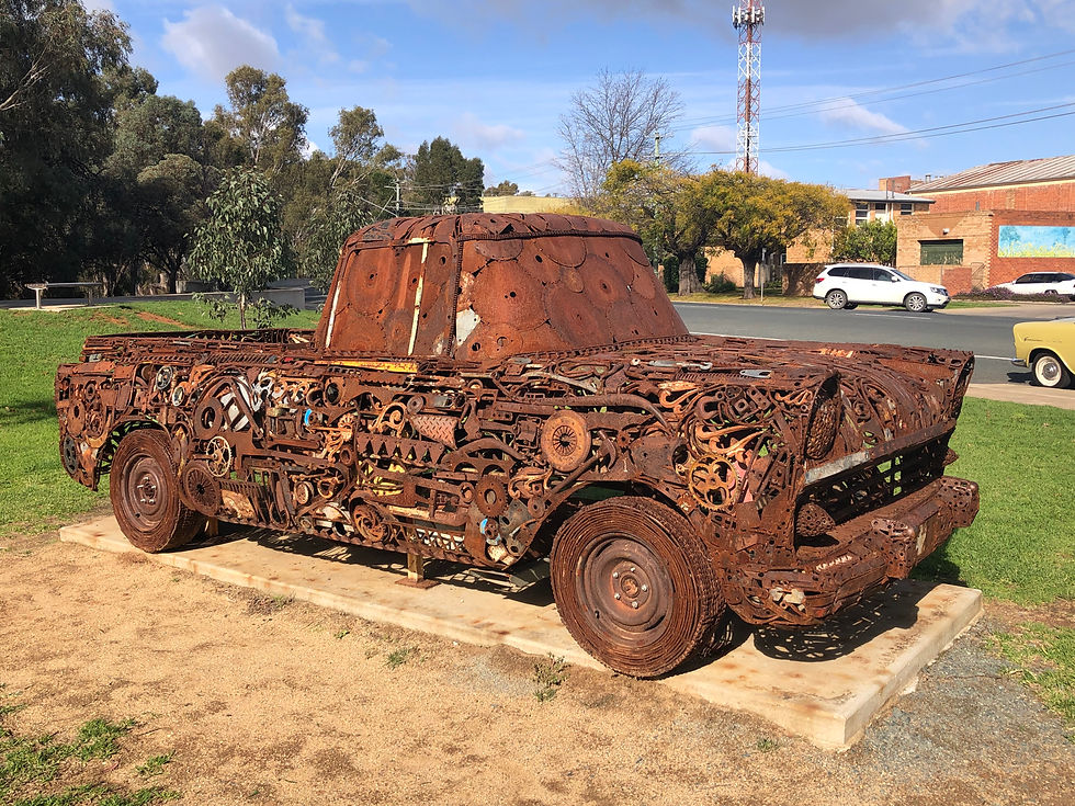 rusty farm equipment in a park