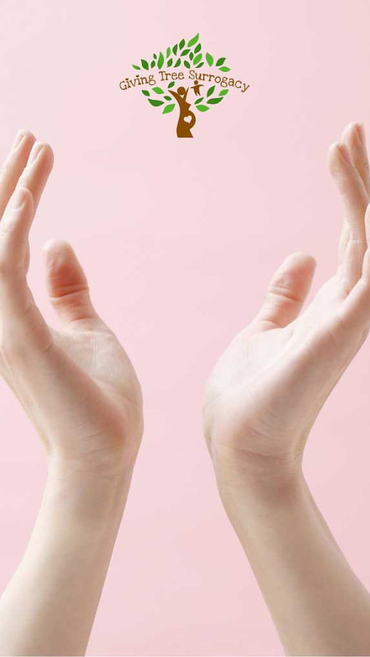 Open hands raised against a soft pink background, symbolizing hope, care, and the giving nature of the surrogacy process