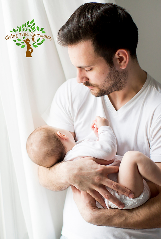 Father gently holding his newborn baby near a window, symbolizing the joy and fulfillment of parenthood through surrogacy
