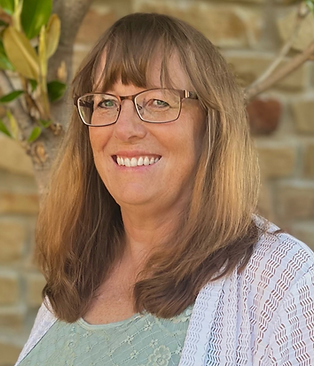 Portrait of Tracey Lujan, Case Manager at Giving Tree Surrogacy, smiling kindly