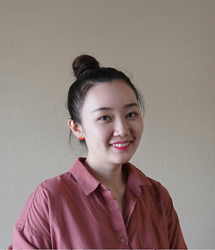 Portrait of Esther Chen, Case Manager at Giving Tree Surrogacy, smiling thoughtfully