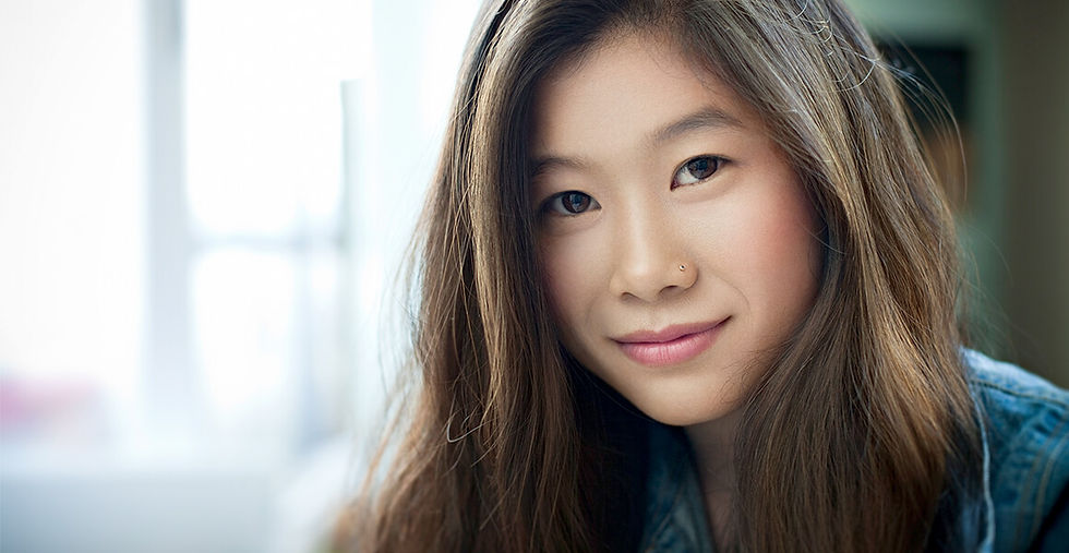 Close-up portrait of a young woman smiling softly, representing confidence and readiness to become an egg donor