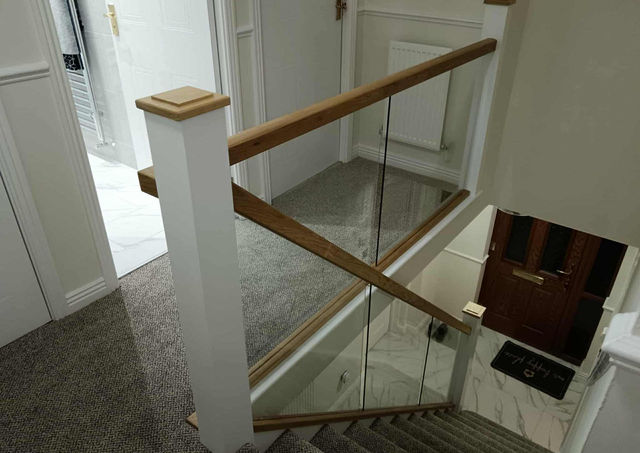 Staircase Renovation, cladded newel post, custom made oak newel cap, oak hadrails, glass panels