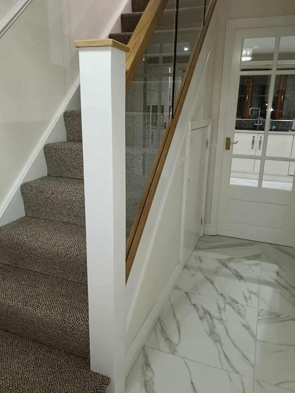 Staircase Renovation, cladded newel post, custom made oak newel cap, oak hadrails, glass panels
