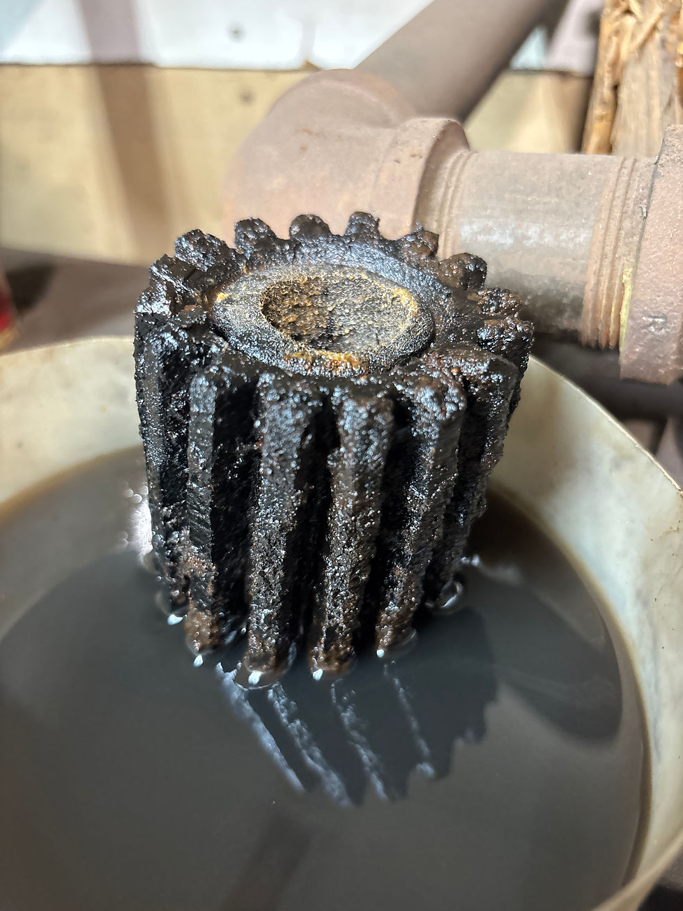 Eye-level view of a heating oil filter and fuel line connected near a tank.