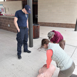 men getting training on CPR with CPR dummies