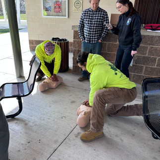 men getting training on CPR with CPR dummies
