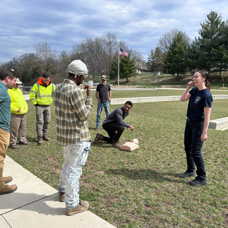 men getting training on CPR with CPR dummies