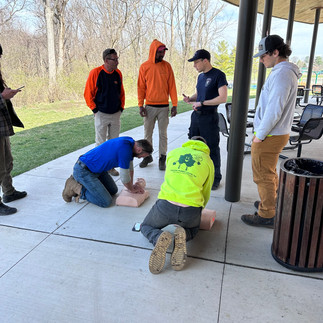 men getting training on CPR with CPR dummies