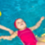 happy child floating in pool
