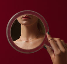 a woman looking in the mirror