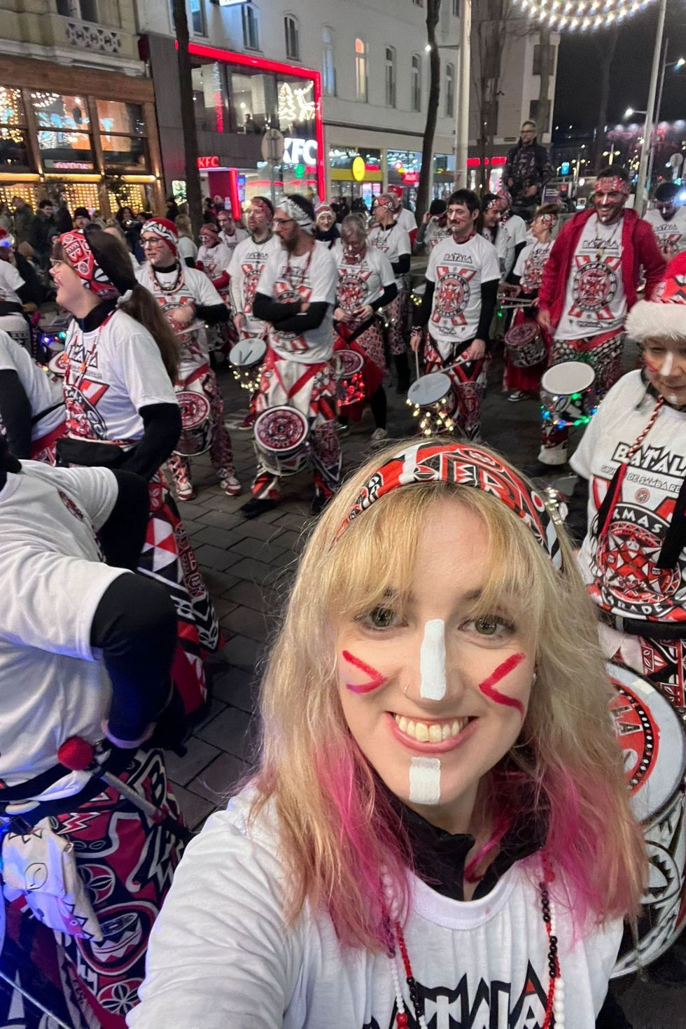 Group of people in festive attire with drums.