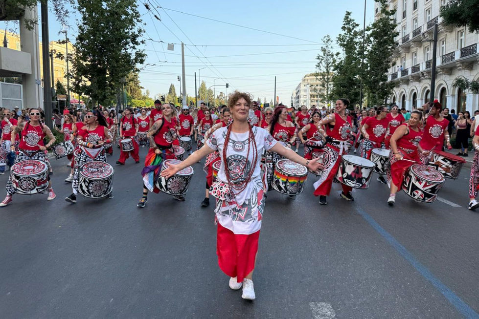 Batala players parading while the caller leads them