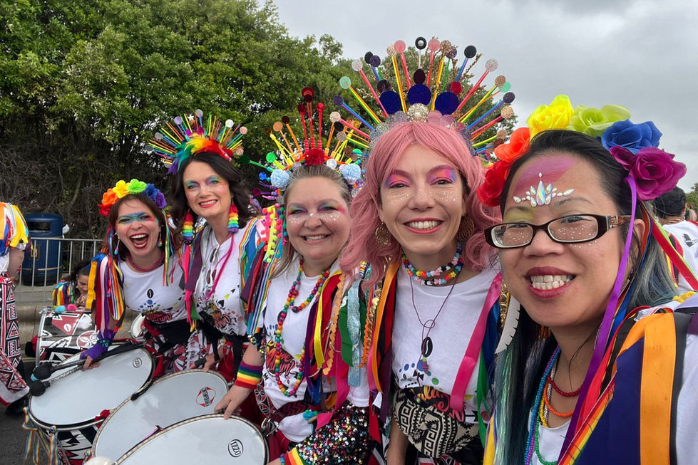 Dobras posing for a picture in colourful Pride accessories before the parade
