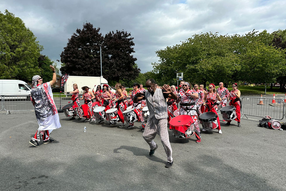 Batala Manchester players in costume playing