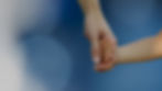 Adult and child holding hands