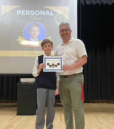 Student and teach holding an award certificate together.