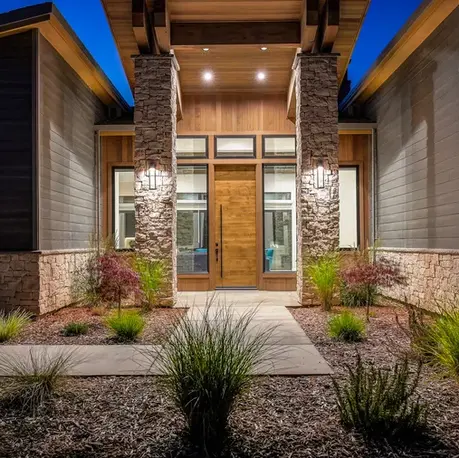 Lit entry doors framed by stone columns at dusk in Somerset, CA