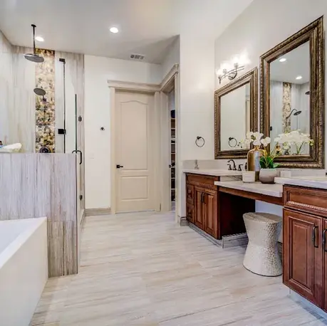 Primary bathroom with twin vanities, a soaking tub and walk-in shower in The Motherlode