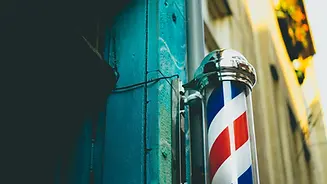 Classic barber pole outside Barbery Coast Barber Shop