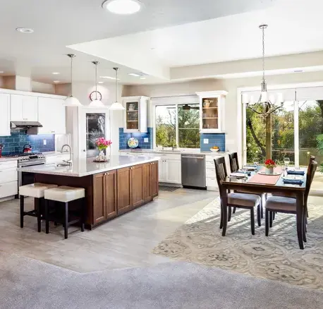 Kitchen and dining area with a dark wood island and blue tile backsplash in Auburn, CA