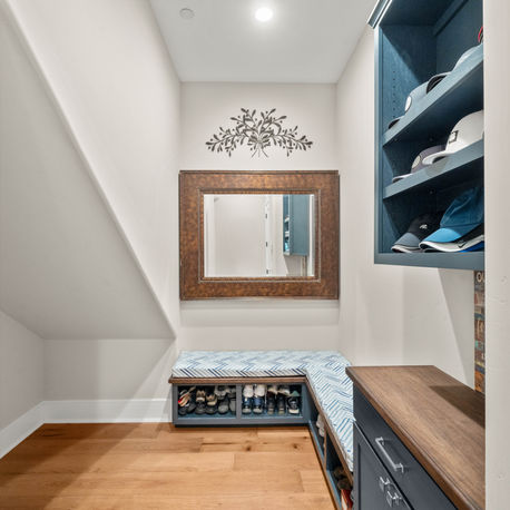Mudroom bench with shoe storage and a built-in locker at The Ridge